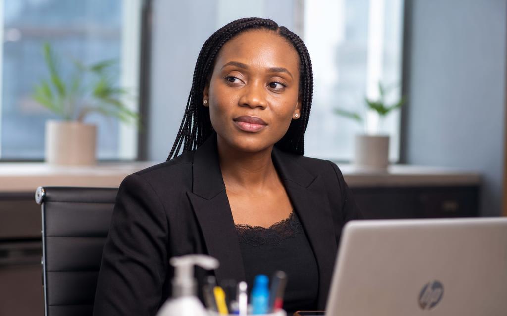 Nigerian professional woman working on a laptop in an office